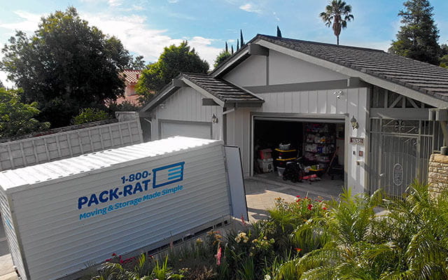 box-packrat 1-800-PACK-RAT container in a driveway — Too Good Movers loads and unloads PACK-RAT containers in Las Vegas